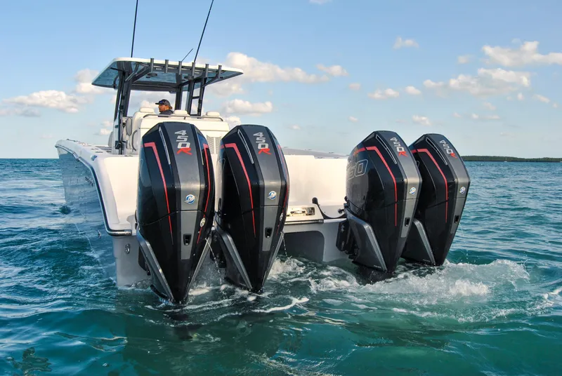Slide: The Image of 2020 Invincible 40 Catamaran with quad outboard engines cruising on open water. - 19