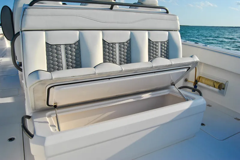 Slide: The Image of Invincible 40 Catamaran 2020 with open storage compartment on deck, ocean in background. - 33