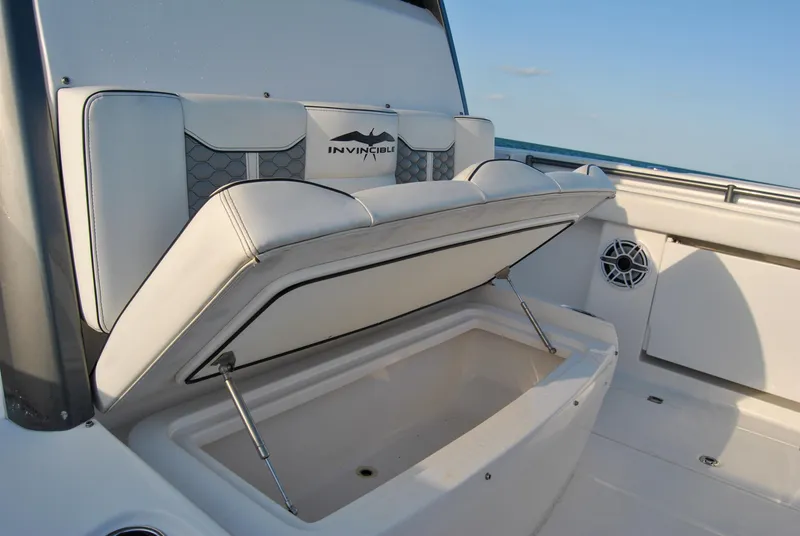Slide: The Image of Invincible 40 Catamaran 2020 with open storage compartment and cushioned seating. - 34
