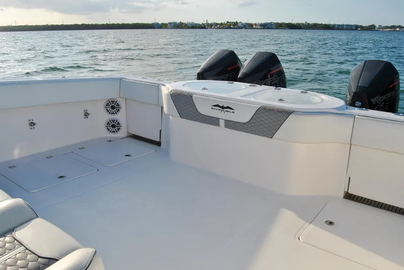 Slide: The Image of Invincible 40 Catamaran 2020 model, spacious deck with twin outboard motors on the water. - 35