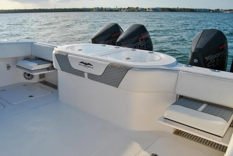 Slide: The Image of 2020 Invincible 40 Catamaran boat interior with twin outboard motors on the water. - 36