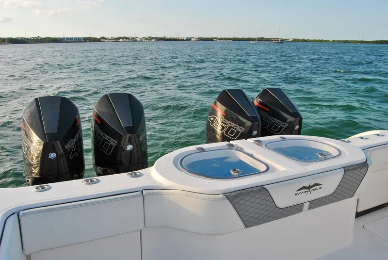 Slide: The Image of 2020 Invincible 40 Catamaran with quad outboard engines on the water. - 38