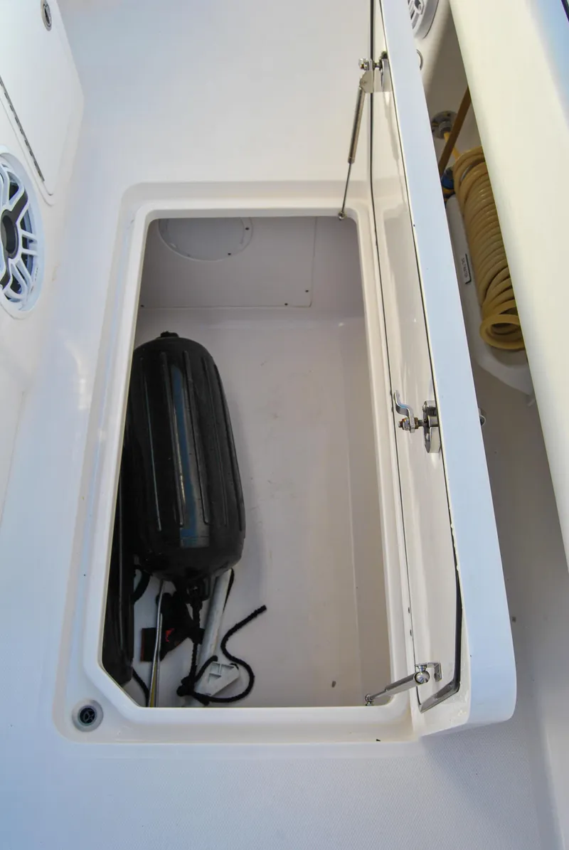 Slide: The Image of Storage compartment on a 2020 Invincible 40 Catamaran with a black bag and coiled hose. - 39