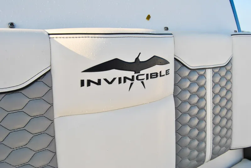 Slide: The Image of Close-up of Invincible 40 Catamaran 2020 logo on white and gray boat upholstery. - 42