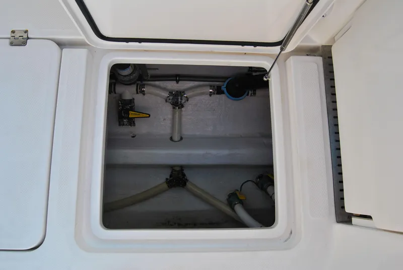 Slide: The Image of Open hatch of a 2020 Invincible 40 Catamaran showing internal plumbing and components. - 46
