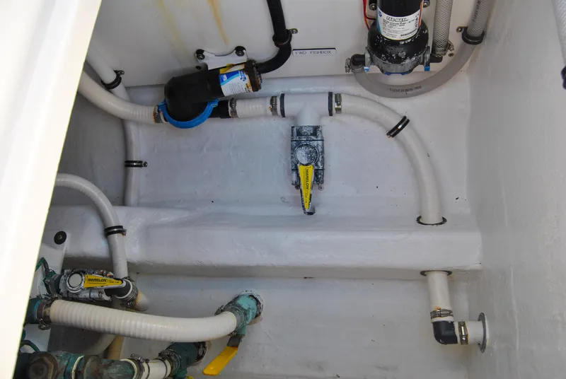 Slide: The Image of Engine compartment of a 2020 Invincible 40 Catamaran with various hoses and fittings. - 47