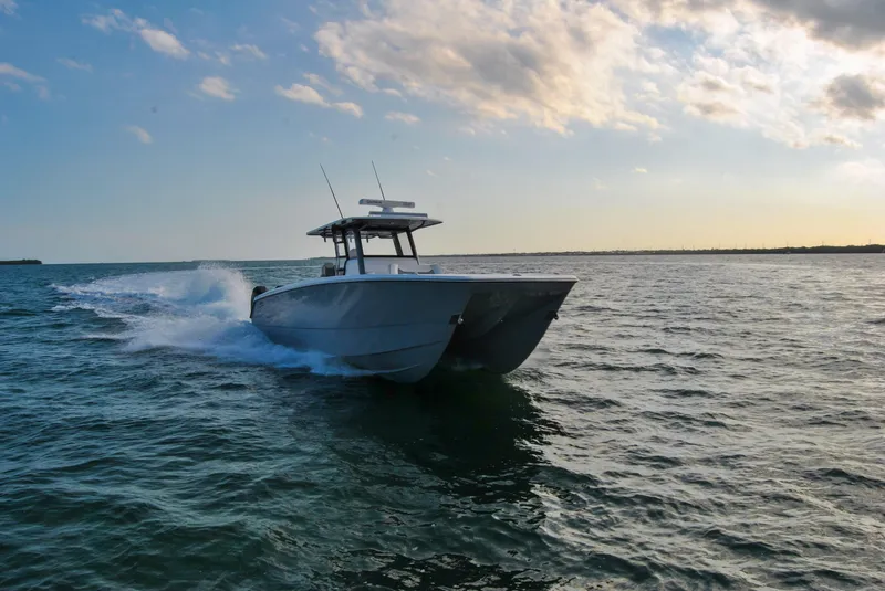 Slide: The Image of 2020 Invincible 40 Catamaran cruising on open water at sunset. - 5