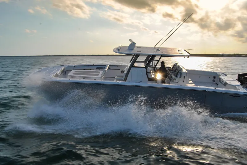 Slide: The Image of 2020 Invincible 40 Catamaran cruising on open water at sunset. - 8