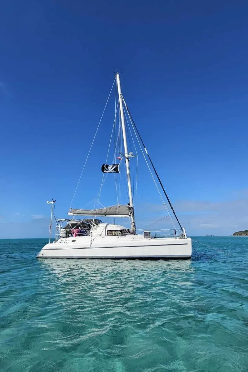 The Image of 1992 Fountaine Pajot Antigua 37 catamaran sailing on clear blue waters. - 0