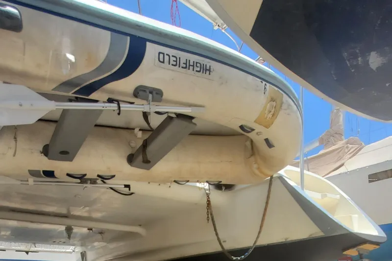 Slide: The Image of Fountaine Pajot Antigua 37 (1992) catamaran with attached dinghy in a marina. - 12