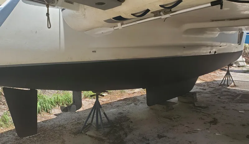 Slide: The Image of 1992 Fountaine Pajot Antigua 37 catamaran hull on stands for maintenance. - 14