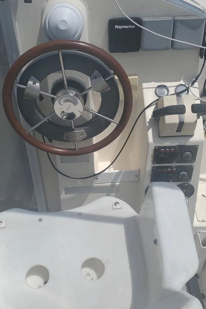 Slide: The Image of Cockpit of a 1992 Fountaine Pajot Antigua 37 catamaran with steering wheel and navigation instruments. - 18