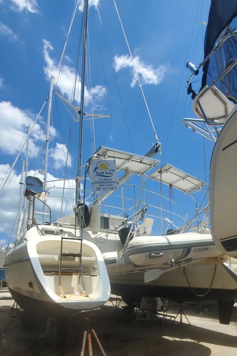 Slide: The Image of 1992 Fountaine Pajot Antigua 37 catamaran docked under a clear blue sky. - 2