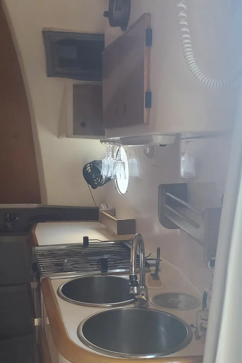 Slide: The Image of 1992 Fountaine Pajot Antigua 37 yacht kitchen with dual sinks and wooden cabinetry. - 30
