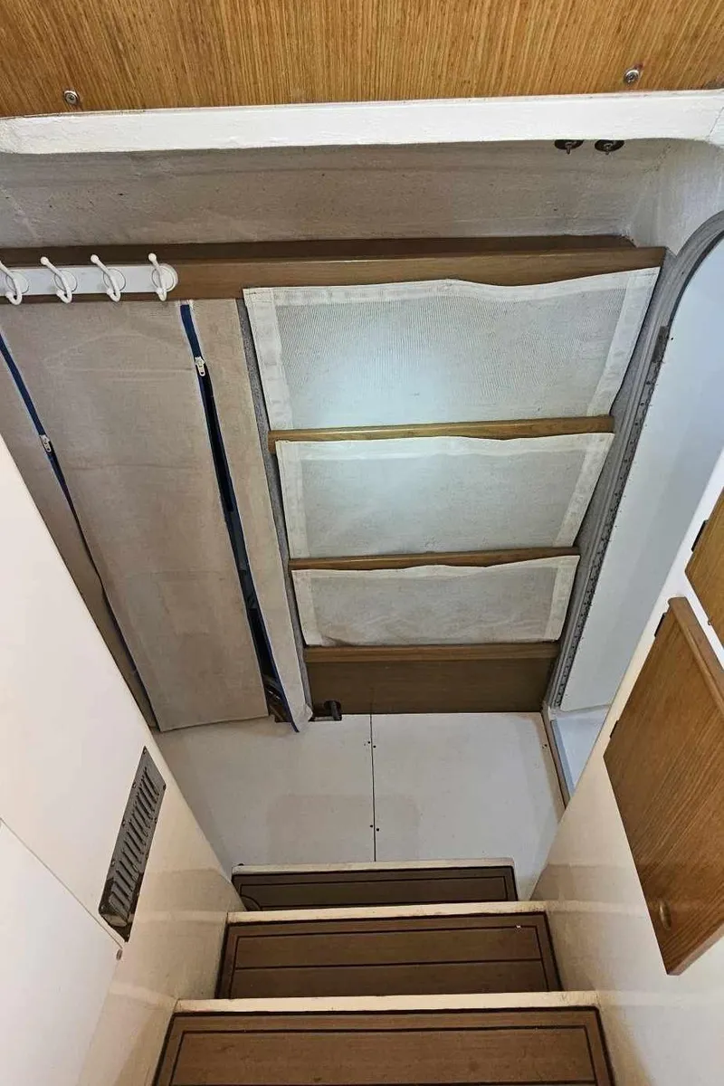 Slide: The Image of Interior view of 1992 Fountaine Pajot Antigua 37 catamaran with wooden steps and storage compartments. - 36