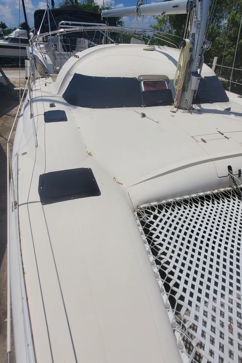 Slide: The Image of 1992 Fountaine Pajot Antigua 37 catamaran deck with netting and hatches. - 7