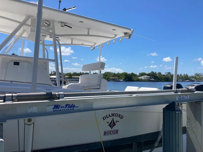 Slide: The Image of 2014 Marlago 35 boat named Diamond in the Rough docked by the water. - 13