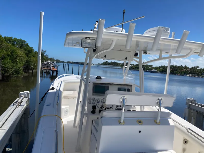 Slide: The Image of 2014 Marlago 35 boat docked on a sunny day with a scenic waterway view. - 14