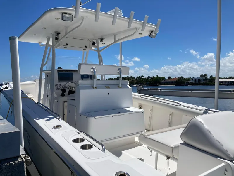 Slide: The Image of 2014 Marlago 35 boat with white interior docked by the water on a sunny day. - 15