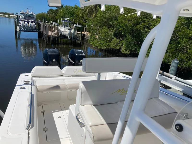 Slide: The Image of 2014 Marlago 35 boat with twin engines docked in a serene marina. - 19