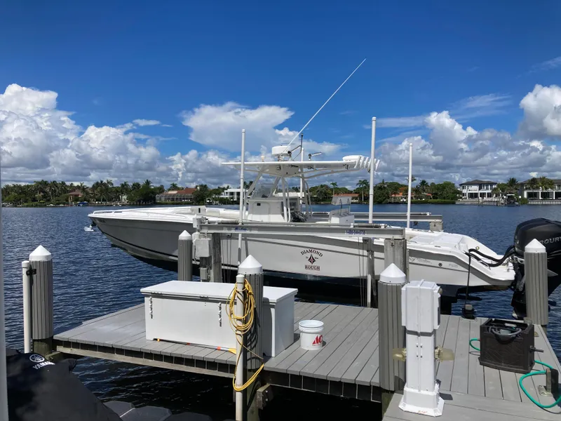 Slide: The Image of 2014 Marlago 35 boat docked on a sunny day with blue skies. - 20