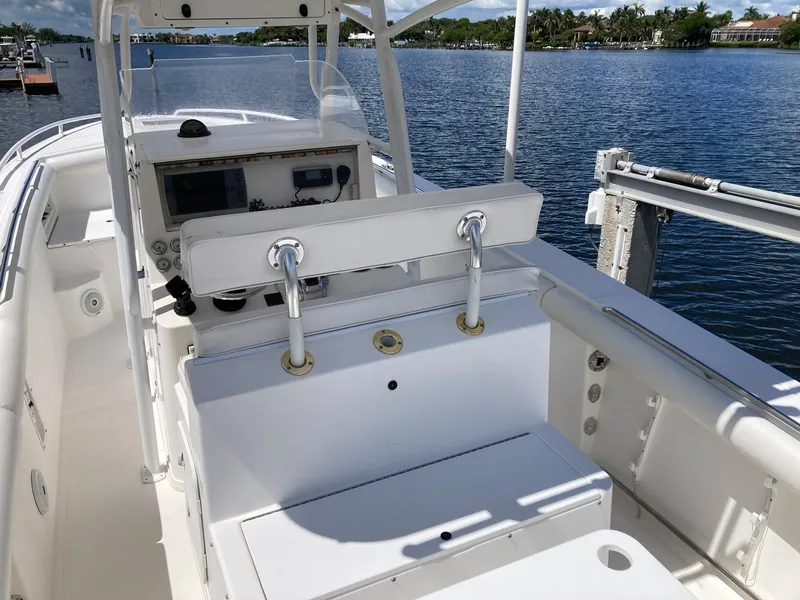 Slide: The Image of 2014 Marlago 35 boat interior with helm station and seating, docked by a serene waterfront. - 25