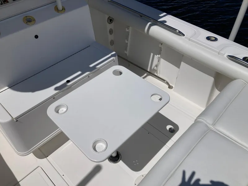 Slide: The Image of 2014 Marlago 35 boat interior with white seating and table. - 26