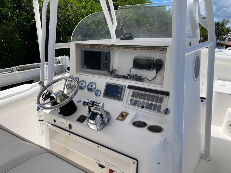 Slide: The Image of 2014 Marlago 35 boat dashboard with steering wheel, gauges, and navigation equipment. - 29