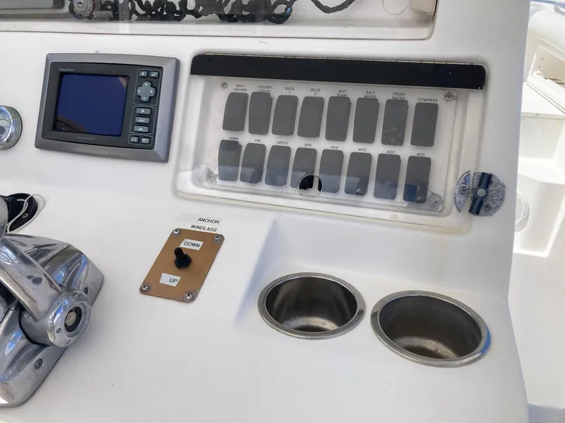 Slide: The Image of Control panel of a 2014 Marlago 35 boat with switches and display. - 30