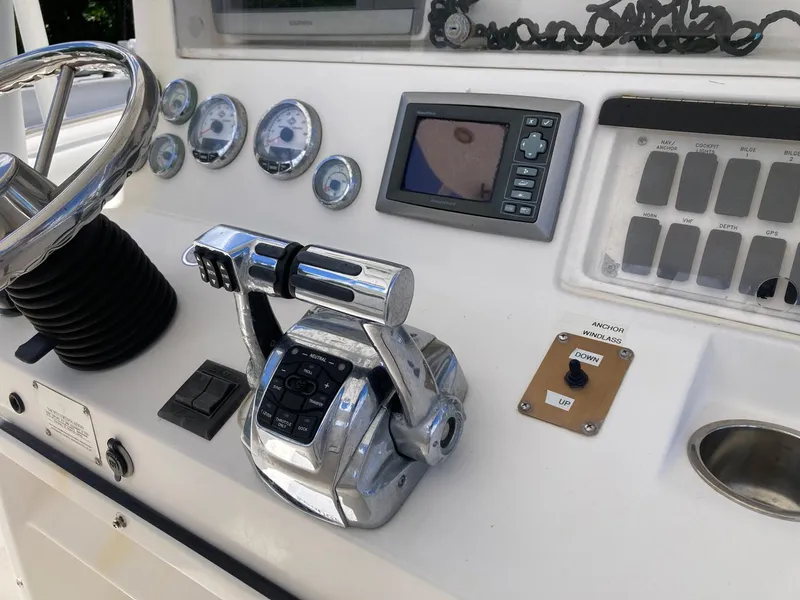 Slide: The Image of Control panel of a 2014 Marlago 35 boat with steering wheel and navigation instruments. - 31