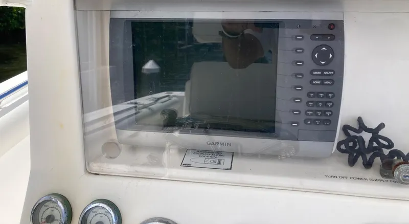 Slide: The Image of Garmin navigation system on a 2014 Marlago 35 boat dashboard. - 33