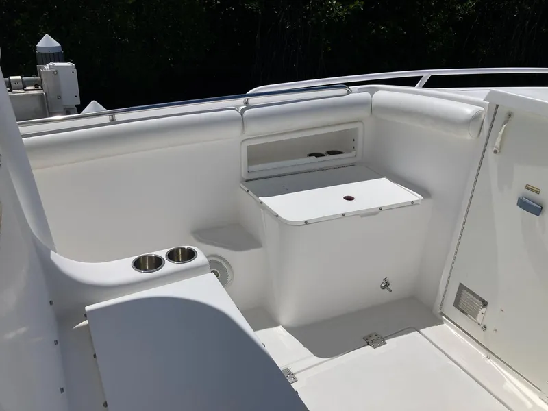 Slide: The Image of 2014 Marlago 35 boat interior with storage compartments and cup holders. - 35