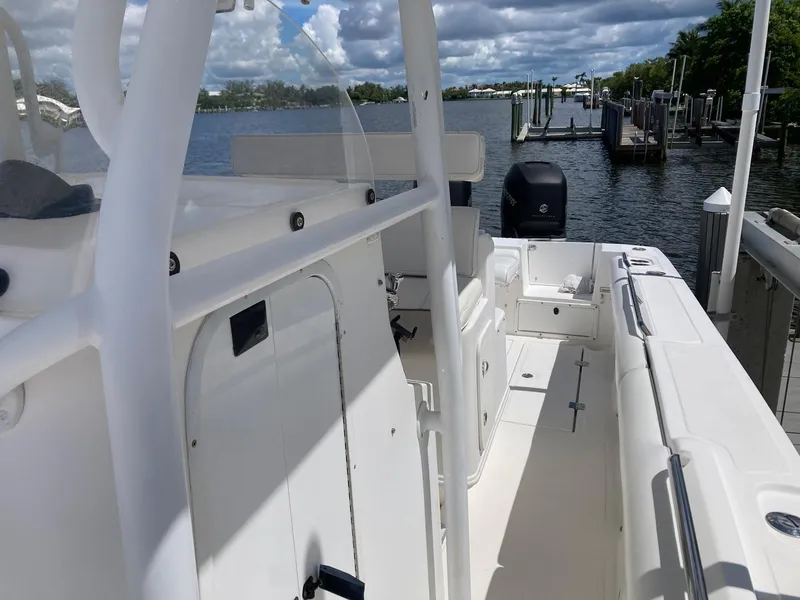 Slide: The Image of 2014 Marlago 35 boat docked at a marina on a cloudy day. - 36
