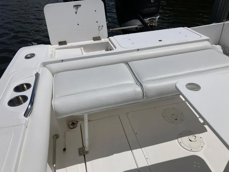 Slide: The Image of 2014 Marlago 35 boat with white cushioned seating and cup holders. - 42