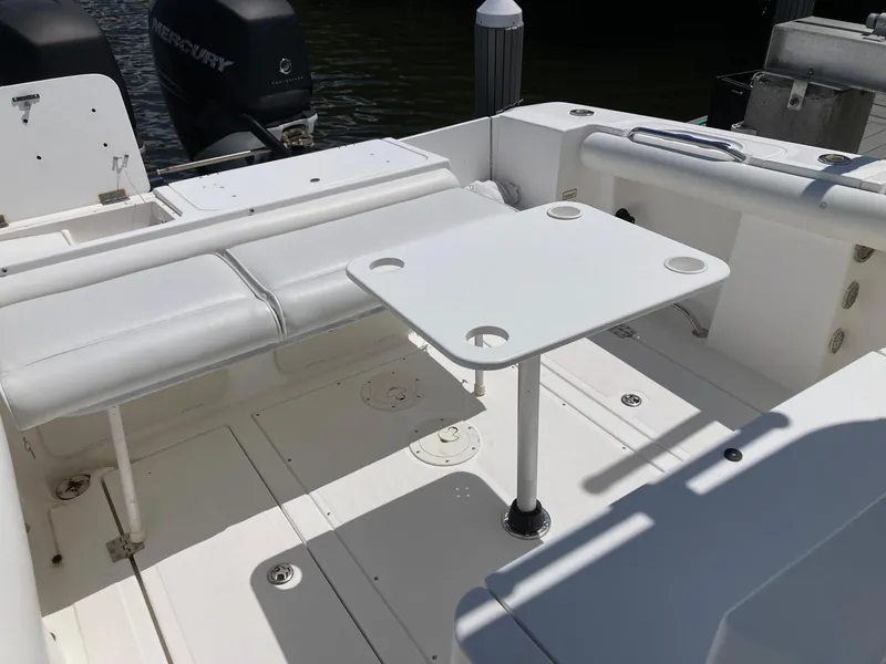 Slide: The Image of 2014 Marlago 35 boat interior with seating and table, featuring Mercury outboard engines. - 43