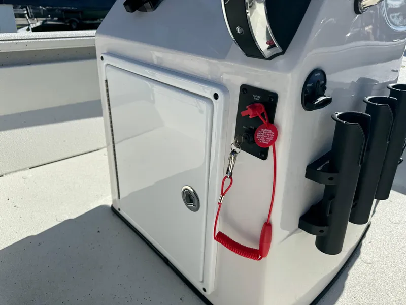 Slide: The Image of 2024 Ranger RB210 boat console with red safety lanyard and storage compartment. - 6