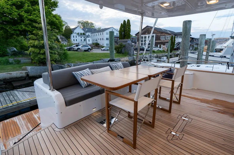 Slide: The Image of 2024 Sirena 58 Flybridge yacht with outdoor dining area and seating. - 11
