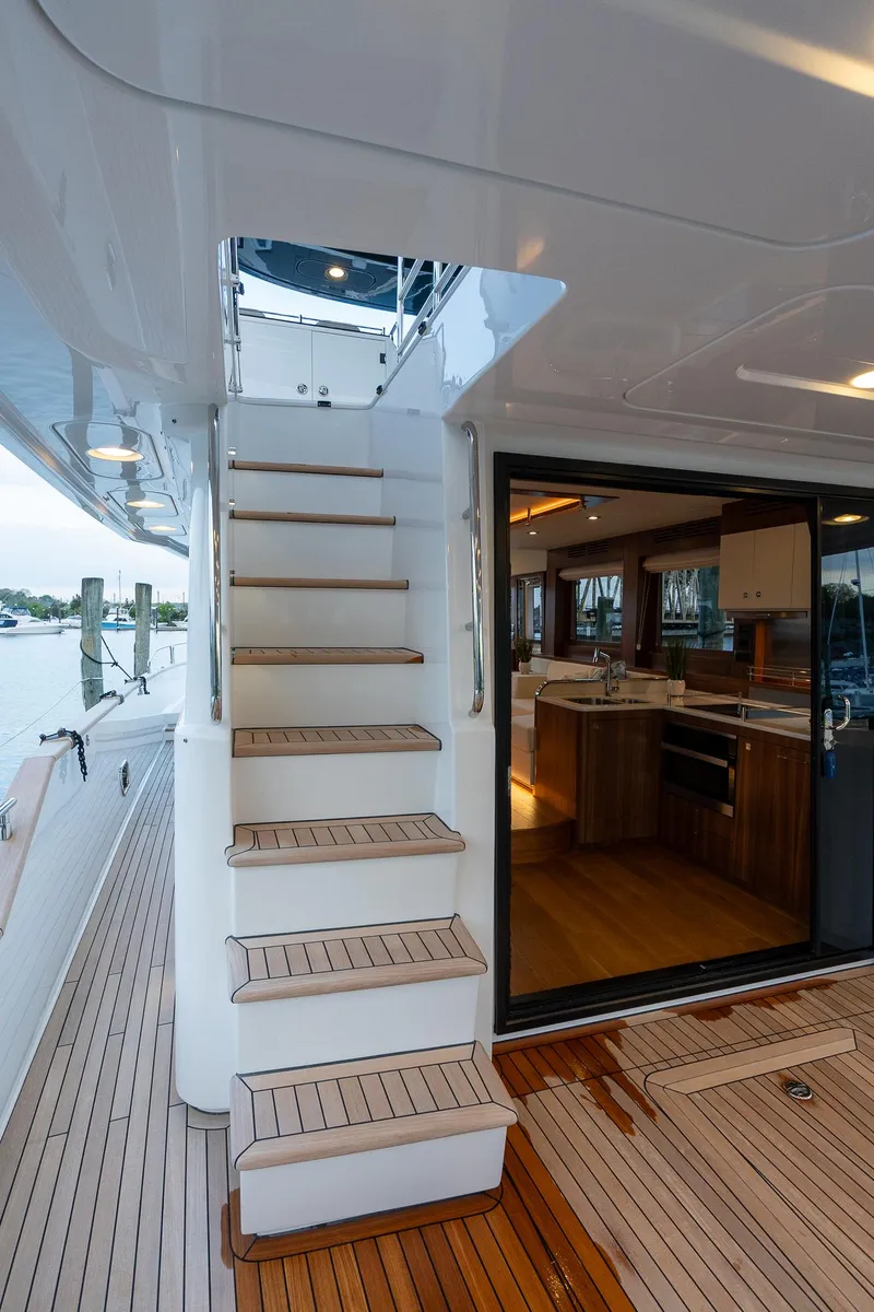 Slide: The Image of 2024 Sirena 58 Flybridge yacht with teak stairs and modern interior. - 17