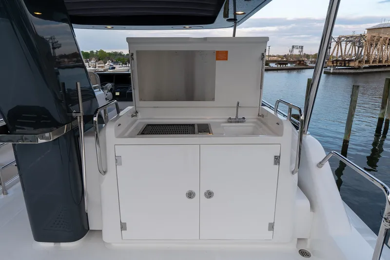 Slide: The Image of 2024 Sirena 58 Flybridge yacht outdoor kitchen with sink and grill. - 20