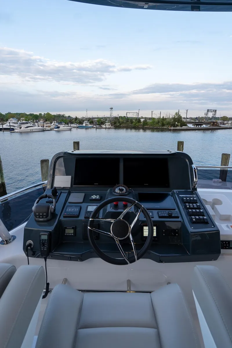 Slide: The Image of 2024 Sirena 58 Flybridge yacht helm station with marina view - 30