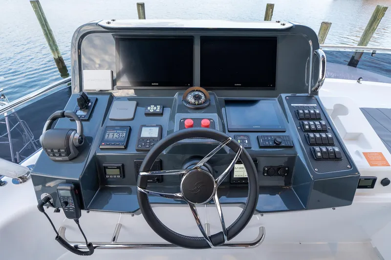 Slide: The Image of 2024 Sirena 58 Flybridge helm station with dual screens and advanced controls. - 32