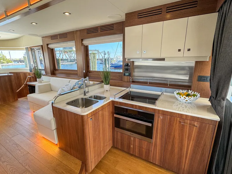 Slide: The Image of Modern kitchen and living area on 2024 Sirena 58 Flybridge yacht with wood finishes and ocean views. - 39