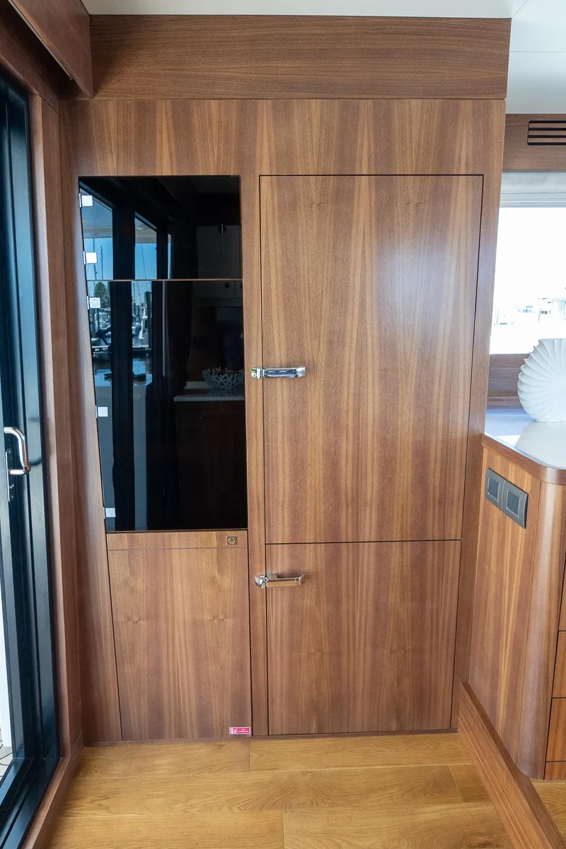 Slide: The Image of 2024 Sirena 58 Flybridge yacht interior with wooden cabinetry and modern design. - 42