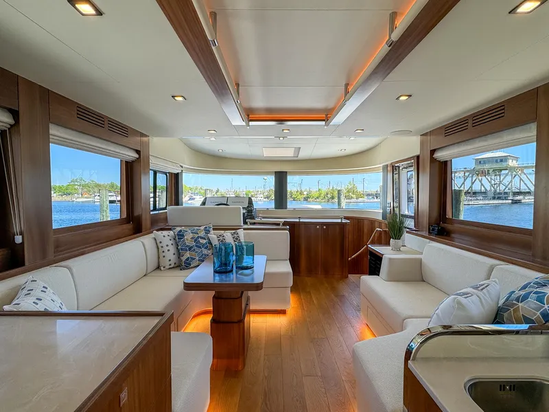 Slide: The Image of Luxurious interior of 2024 Sirena 58 Flybridge yacht with panoramic windows and elegant seating. - 45