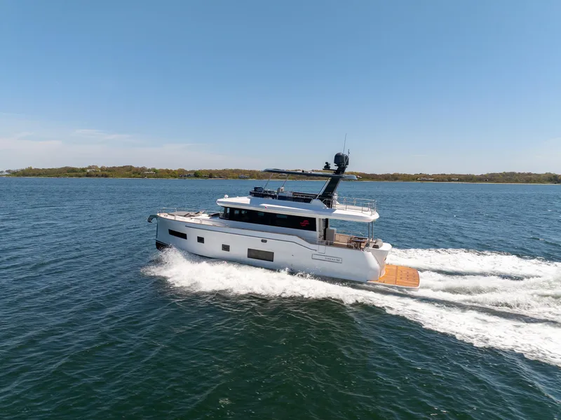 Slide: The Image of 2024 Sirena 58 Flybridge yacht cruising on open water. - 5
