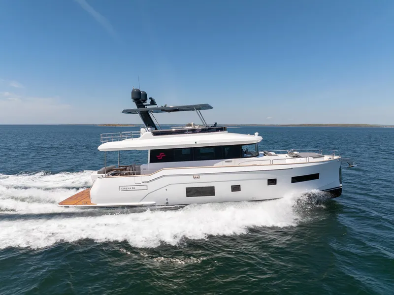 Slide: The Image of 2024 Sirena 58 Flybridge yacht cruising on open water. - 7