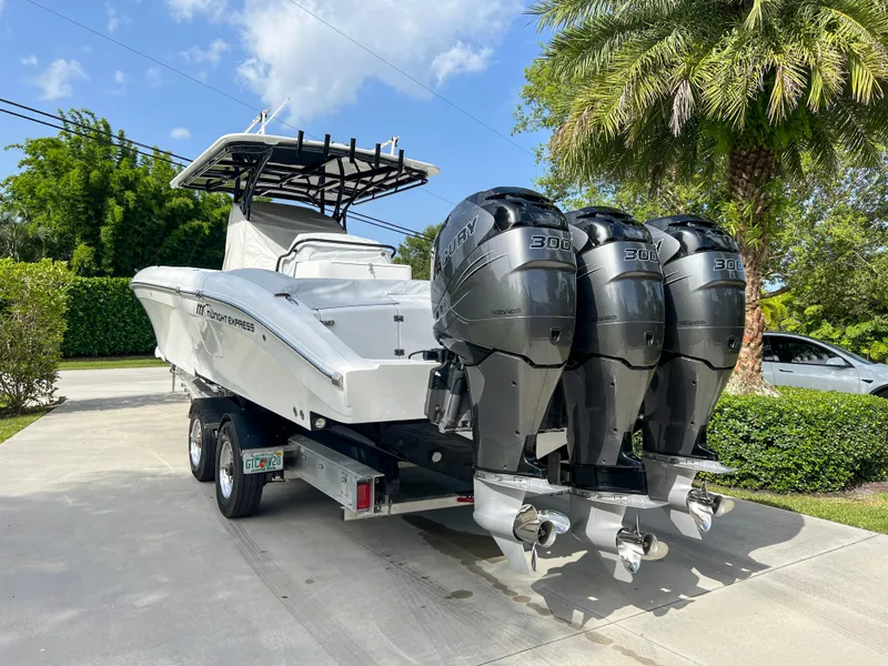 Slide: The Image of 2014 Midnight Express 37 Open boat with triple 300 HP engines on a trailer. - 14