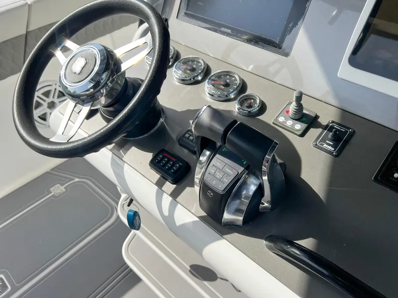 Slide: The Image of 2014 Midnight Express 37 Open boat helm with steering wheel and control panel. - 25