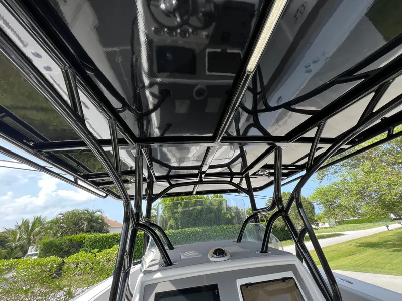 Slide: The Image of 2014 Midnight Express 37 Open boat with black T-top and console. - 26