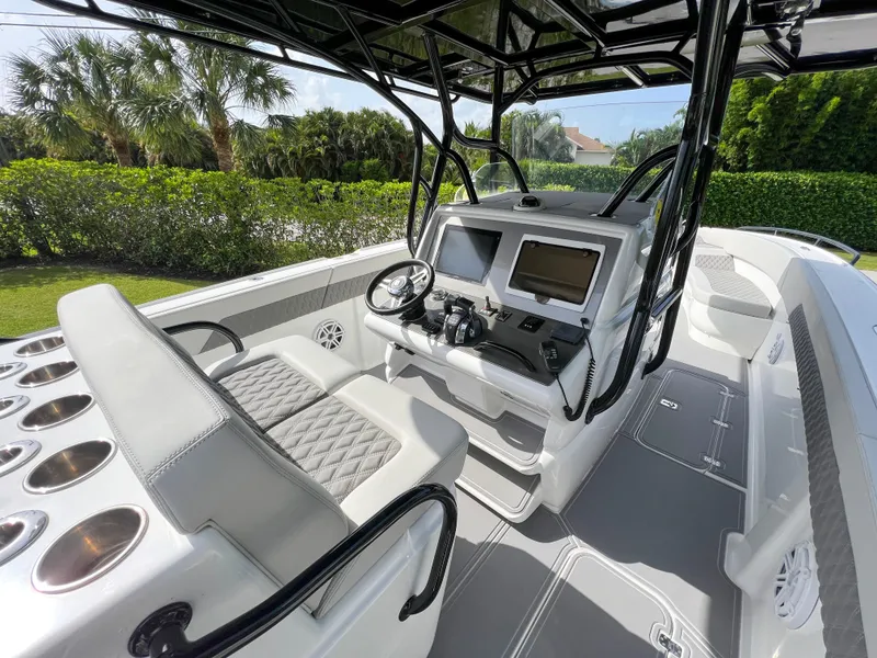 Slide: The Image of 2014 Midnight Express 37 Open boat cockpit with dual seats and advanced navigation system. - 29